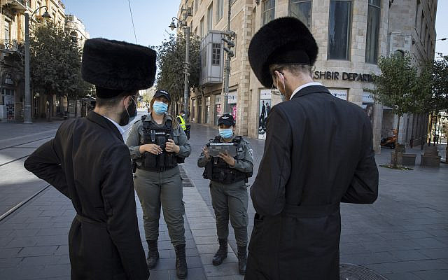 Israeli border police officers check citizents on Jaffa Street in downtown Jerusalem on October 7, 2020, during a nationwide lockdown to prevent the spread of COVID-19. (Nati Shohat/Flash90) Israeli border police officers check citizents on Jaffa Street in downtown Jerusalem on October 7, 2020, during a nationwide lockdown to prevent the spread of COVID-19. (Nati Shohat/Flash90)