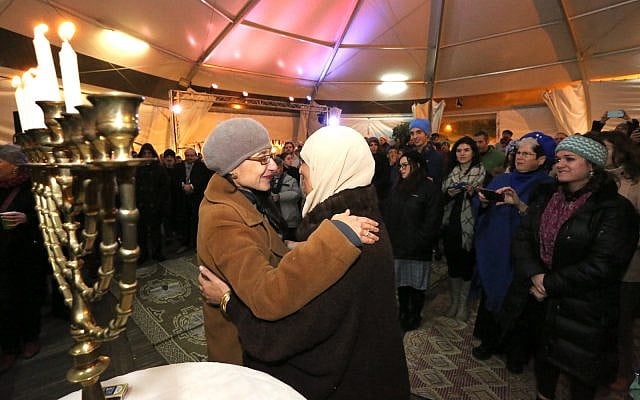 Illustrative: Jews and Arabs light Hanukkah candles at an interfaith event at the First Station compound in Jerusalem on December 10, 2015. Rabbi Tamar Elad-Appelbaum is on right. (Yossi Zamir/Flash90) Illustrative: Jews and Arabs light Hanukkah candles at an interfaith event at the First Station compound in Jerusalem on December 10, 2015. Rabbi Tamar Elad-Appelbaum is on right. (Yossi Zamir/Flash90)