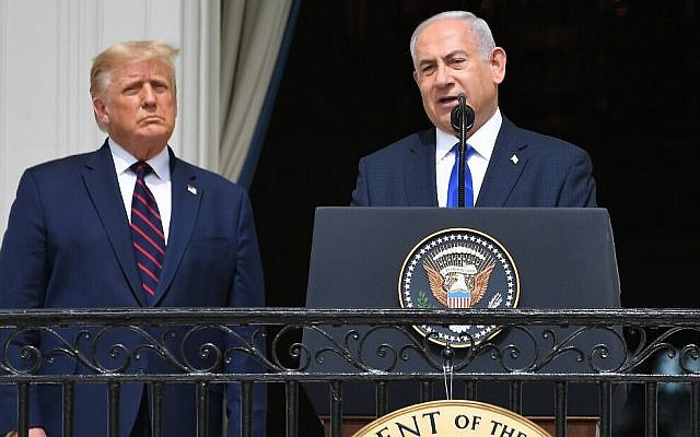 US President Donald Trump watches as Prime Minister Benjamin Netanyahu speaks from the Truman Balcony at the White House during the signing ceremony of the Abraham Accords where the countries of Bahrain and the United Arab Emirates recognize Israel, on the South Lawn of the White House in Washington, DC, September 15, 2020. (Photo by SAUL LOEB / AFP)