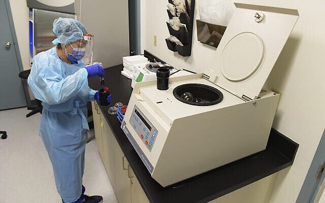 FILE - This Wednesday, Sept, 2, 2020, file photo shows University of Miami Miller School of Medicine lab tech Sendy Puerto processing blood samples in the specimen processing lab￼ from study participants who volunteered to take part in testing the National Institutes of Health-funded Moderna COVID-19 vaccine in Miami. Sen. Rob Portman, R-Ohio, is participating in a COVID-19 vaccine study, hoping to encourage others to volunteer to take part in testing. (AP Photo/Taimy Alvarez, File)