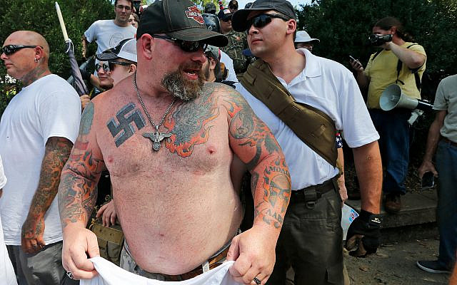 A white supremacist leaves Emancipation Park in Charlottesville, Virginia, August 12, 2017. (AP Photo/Steve Helber)