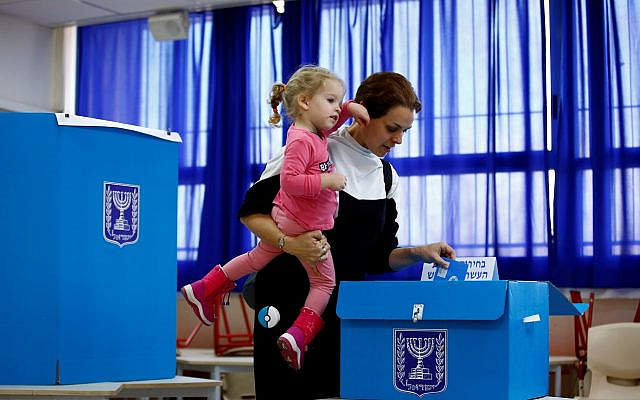 A woman casts her ballot as she votes in Israel's national election at a polling station in Tel Aviv, Israel, March 2, 2020. (REUTERS/ Corinna Kern, used with permission) A woman casts her ballot as she votes in Israel's national election at a polling station in Tel Aviv, Israel, March 2, 2020. (REUTERS/ Corinna Kern, used with permission)