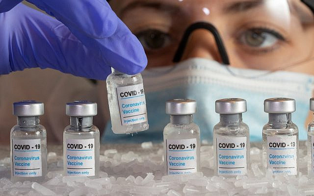 Woman holds a vial labelled "COVID-19 Coronavirus Vaccine" over dry ice in this illustration taken, December 5, 2020. REUTERS/Dado Ruvic/Illustration Woman holds a vial labelled "COVID-19 Coronavirus Vaccine" over dry ice in this illustration taken, December 5, 2020. REUTERS/Dado Ruvic/Illustration