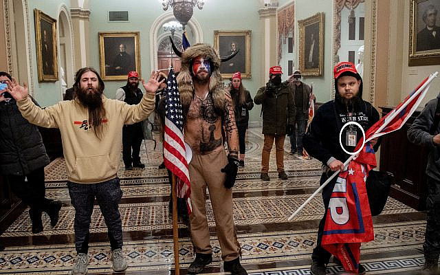 Supporters of US President Donald Trump, including Jake Angeli (C), a QAnon supporter, enter the Capitol in Washington, DC, on January 6, 2021.(Saul LOEB / AFP)