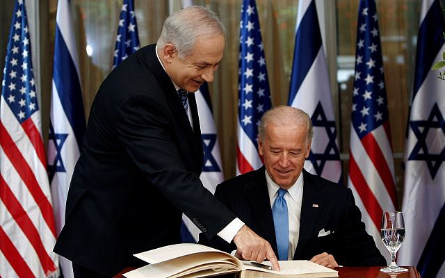 FILE PHOTO: U.S. Vice President Joe Biden (R) prepares to sign the guest book before his meeting with Israel's Prime Minister Benjamin Netanyahu at Netanyahu's residence in Jerusalem March 9, 2010. REUTERS/Ronen Zvulun/File Photo