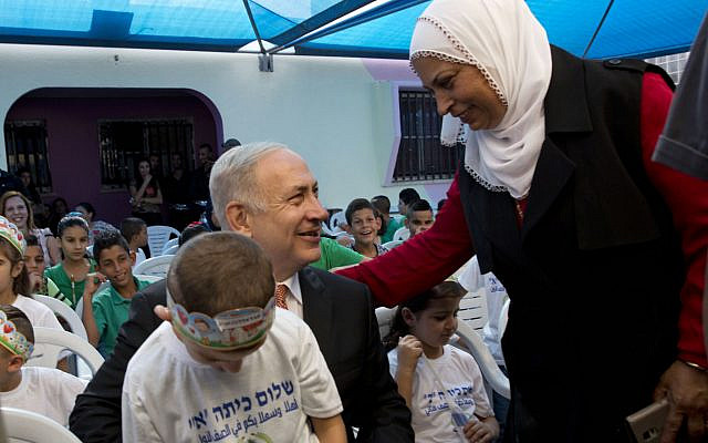 Illustrative: Prime Minister Benjamin Netanyahu poses for a photograph with pupils on the first day of school in the Israeli Arab town of Tamra, September 1, 2016. (AP/Sebastian Scheiner) Illustrative: Prime Minister Benjamin Netanyahu poses for a photograph with pupils on the first day of school in the Israeli Arab town of Tamra, September 1, 2016. (AP/Sebastian Scheiner)