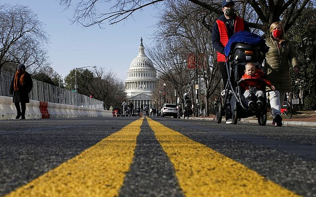 People try to see the Capitol as streets are blocked for security reasons ahead of U.S. President-elect Joe Biden's inauguration, in Washington, U.S., January 16, 2021. REUTERS/Eduardo Munoz     TPX IMAGES OF THE DAY