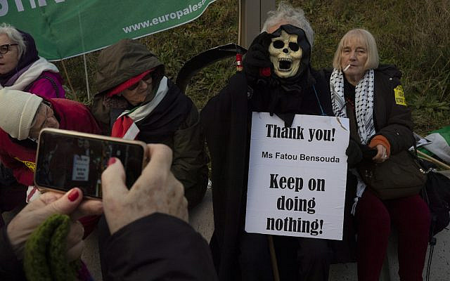 A woman takes a picture of the Grim Reaper holding a sign referring to Chief Prosecutor Fatou Bensouda during a demonstration outside the International Criminal Court, ICC, urging the court to prosecute Israel's army for war crimes in The Hague, Netherlands, November 29, 2019. (AP/Peter Dejong) A woman takes a picture of the Grim Reaper holding a sign referring to Chief Prosecutor Fatou Bensouda during a demonstration outside the International Criminal Court, ICC, urging the court to prosecute Israel's army for war crimes in The Hague, Netherlands, November 29, 2019. (AP/Peter Dejong)