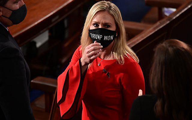 In this Sunday, Jan. 3, 2021, file photo, Rep. Marjorie Taylor Greene, R-Ga., wears a 'Trump Won' face mask as she arrives on the floor of the House to take her oath of office on opening day of the 117th Congress at the US Capitol in Washington. (Erin Scott/Pool Photo via AP, File)