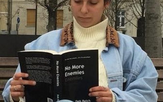 A friend reads No More Enemies in Budapest (courtesy of the author)