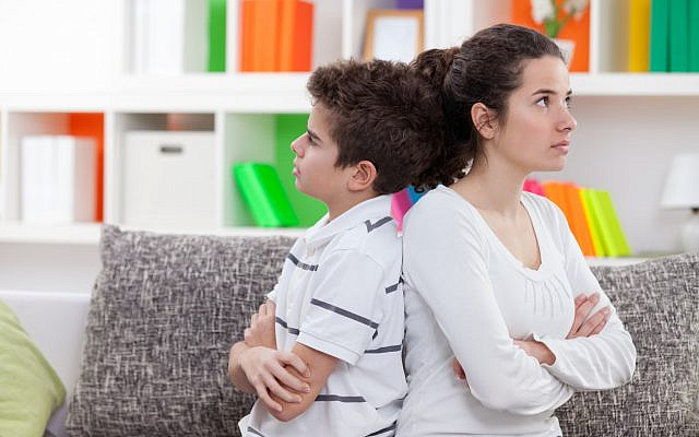 Illustrative. Sibling rivalry: an older sister and younger brother sit back to back on a couch. (iStock) Illustrative. Sibling rivalry: an older sister and younger brother sit back to back on a couch. (iStock)