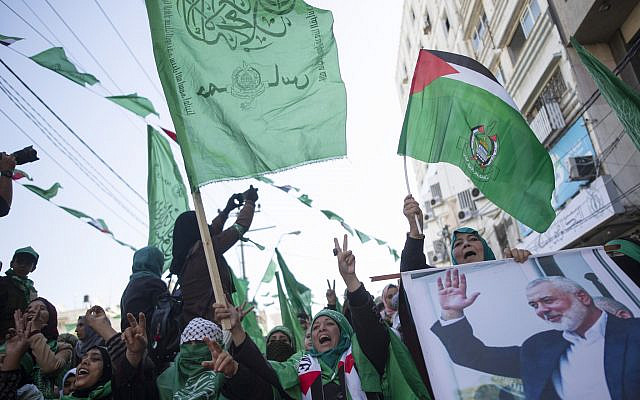 Palestinian women, one holding a picture of Hamas movement chief Ismail Haniyeh, attend a mass rally marking the 32nd anniversary of the founding of Hamas on December 14, 2019, in Gaza city. (AP/Khalil Hamra)