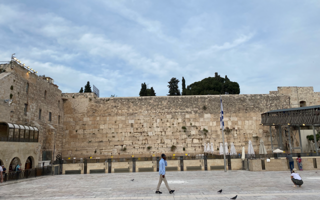 A man walking across the Western Wall, a holy site for Jews in Jerusalem. Taken by me.