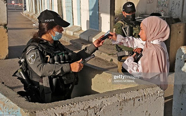 Palestinians make their way through the Qalandia checkpoint by the separation wall between the Israeli-occupied West Bank and Jerusalem, as they head to the Al Aqsa mosque to take part in the third Friday prayers of the Muslim fasting month of Ramadan, on April 30, 2021. (Photo by ABBAS MOMANI / AFP) (Photo by ABBAS MOMANI/AFP via Getty Images)