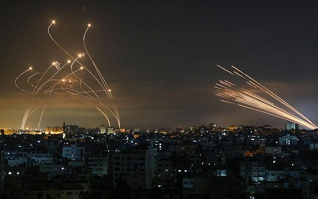 The Israeli Iron Dome missile defense system (left) intercepts rockets fired by Hamas from Beit Lahia in the northern Gaza Strip on May 14, 2021. (Photo by ANAS BABA / AFP) The Israeli Iron Dome missile defense system (left) intercepts rockets fired by Hamas from Beit Lahia in the northern Gaza Strip on May 14, 2021. (Photo by ANAS BABA / AFP)