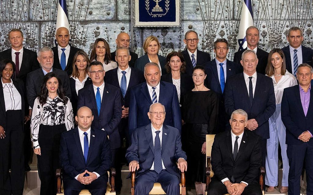 The newly sworn in Israeli government pose for a group photo at the president's residence in Jerusalem on June 14, 2021.(Yonatan Sindel/Flash90)