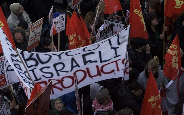 A "Boycott Israeli Products" sign in a UK protest, 2021. Source = Wikimedia (https://commons.wikimedia.org/wiki/File:HANDS_OFF_GAZA_STOP_THE_BOMBING_FREE_PALESTINE_-_UK_NATIONAL_DEMONSTRATION.jpg)