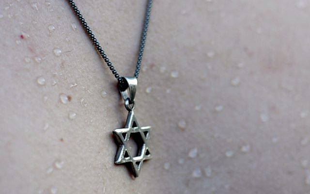 A tourist wears a necklace with a Star of David.  November 30, 2012. Photo by Louis Fisher/Flash90.