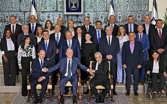 Outgoing Israeli President Reuvin Rivlin (C) is flanked by Prime Minister Naftali Bennett (L) and alternate Prime Minister and Foreign Minister Yair Lapid during a photo with the new coalition government, at the President's residence in Jerusalem, on June 14, 2021. - A motley alliance of Israeli parties on June 13 ended Benjamin Netanyahu's 12 straight years as prime minister, as parliament voted in a new government led by his former ally, right-wing Jewish nationalist Naftali Bennett. (Photo by EMMANUEL DUNAND / AFP) Outgoing Israeli President Reuvin Rivlin (C) is flanked by Prime Minister Naftali Bennett (L) and alternate Prime Minister and Foreign Minister Yair Lapid during a photo with the new coalition government, at the President's residence in Jerusalem, on June 14, 2021. - A motley alliance of Israeli parties on June 13 ended Benjamin Netanyahu's 12 straight years as prime minister, as parliament voted in a new government led by his former ally, right-wing Jewish nationalist Naftali Bennett. (Photo by EMMANUEL DUNAND / AFP)
