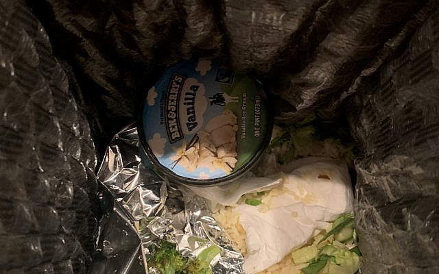 A pint of Ben & Jerry's ice cream in the garbage. (Twitter/@shea1012)