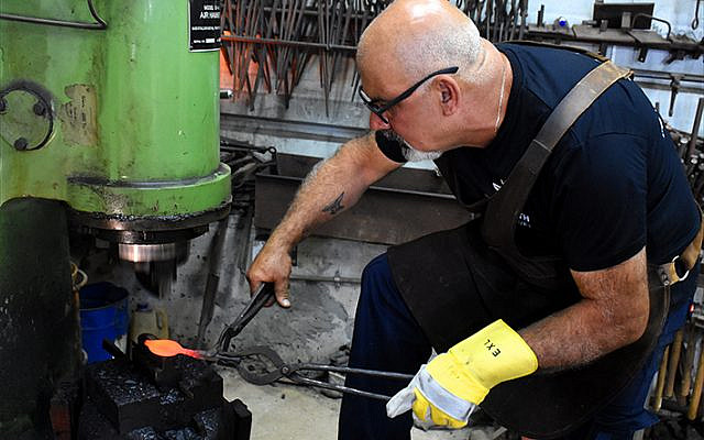 Walied Khoury, one of only two Arab blacksmiths in Israel, at his workshop in Fassouta, a Christian village in Israel’s western Galilee. (Larry Luxner) Walied Khoury, one of only two Arab blacksmiths in Israel, at his workshop in Fassouta, a Christian village in Israel’s western Galilee. (Larry Luxner)