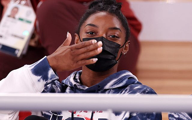 Simone Biles blows a kiss while watching the men's all-around gymnastic final at the Tokyo Olympic Games, July 28, 2021. (Jamie Squire/Getty Images via JTA) Simone Biles blows a kiss while watching the men's all-around gymnastic final at the Tokyo Olympic Games, July 28, 2021. (Jamie Squire/Getty Images via JTA)