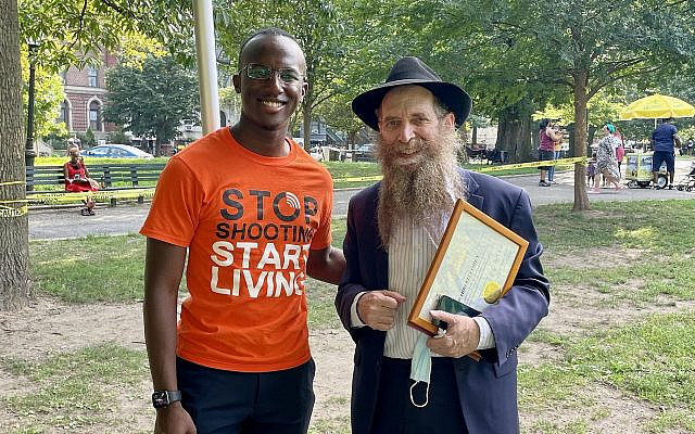 Brooklyn Borough Advocate Jibreel Jalloh, left, and Rabbi Eli Cohen of the Crown Heights Jewish Community Council attend the One Crown Heights festival, marking progress made on the 30th anniversary of the Crown Heights riots, August 2021. (Office of the Public Advocate Jumaane D. Williams)