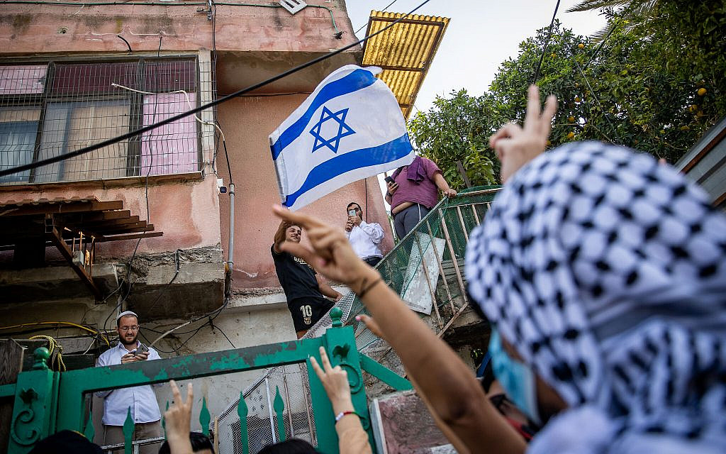Palestinians and left-wing activists protest against the eviction of Palestinian families from their homes in the East Jerusalem neighborhood of Sheikh Jarrah, on April 16, 2021. (Yonatan Sindel/Flash90)