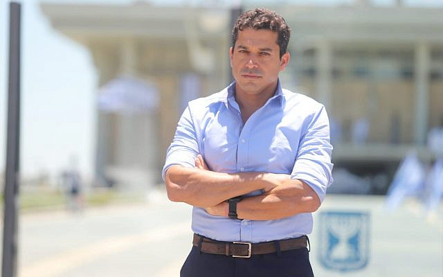 MK Amichai Chikli in front of the Knesset Building (Courtesy)