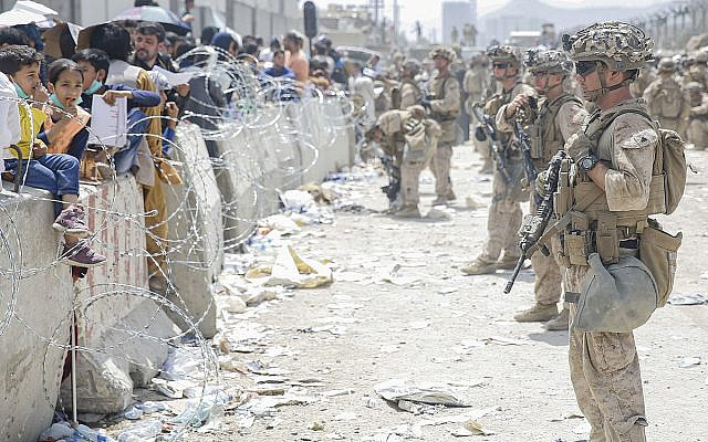 U.S. Marines with Special Purpose Marine Air-Ground Task Force - Crisis Response - Central Command, provide assistance during an evacuation at Hamid Karzai International Airport, Kabul, Afghanistan, Aug. 20. U.S. service members are assisting the Department of State with an orderly drawdown of designated personnel in Afghanistan. (U.S. Marine Corps photo by Lance Cpl. Nicholas Guevara)