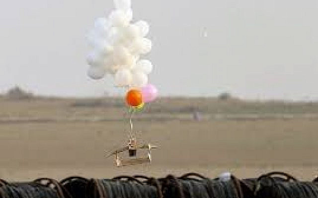 Illustrative. This picture taken on October 19, 2018 in Nahal Oz, from the Israeli side of the border with the northeast of the Gaza Strip, shows balloons carrying an alleged incendiary device launched by Palestinian protesters. (Photo by JACK GUEZ / AFP)
