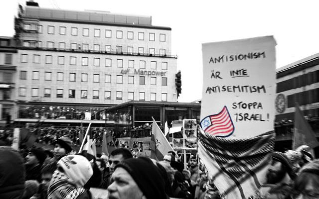 Protesters in Stockholm, Sweden, hold a sign reading "Anti-Zionism is not antisemitism. Stop Israel," Jan. 10, 2009. (Robin/Flickr Commons) Protesters in Stockholm, Sweden, hold a sign reading "Anti-Zionism is not antisemitism. Stop Israel," Jan. 10, 2009. (Robin/Flickr Commons)
