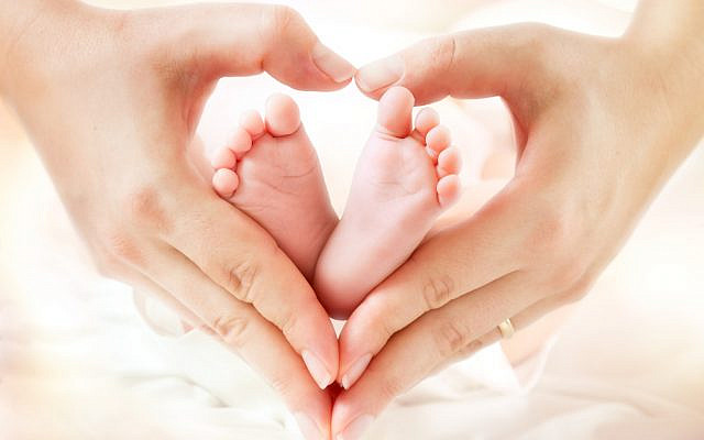 baby feet in mother hands - hearth shape