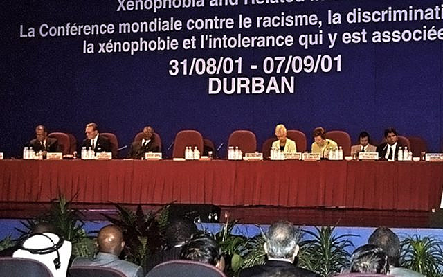 Secretary-General Kofi Annan (right at podium) speaking at the opening of the World Conference Against Racism, Racial Discrimination, Xenophobia and Related Intolerance in Durban.