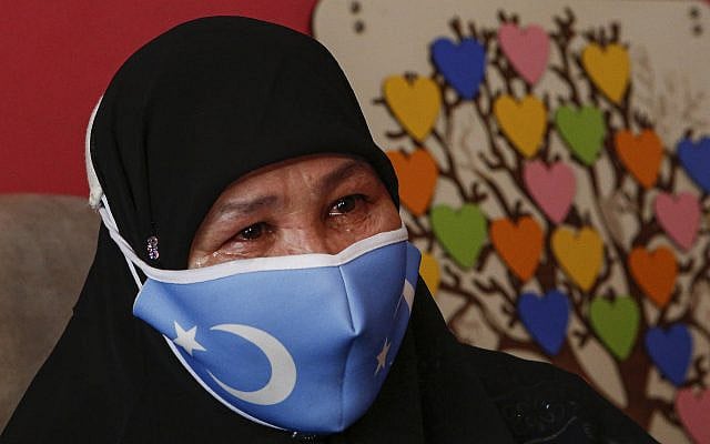 Bumeryem Rozi, 55, an ethnic Uyghur who fled from China to Turkey, cries as she talks at her home, in Istanbul, Tuesday, June 1, 2021. Rozi, a mother of four, is one of three Uyghurs who described forced abortions and torture by Chinese authorities in China's far western Xinjiang region, ahead of giving testimony to a people's tribunal in London, which is investigating if Beijing's actions against the Uyghur ethnic group amount to genocide. Rozi, said authorities in Xinjiang rounded her up along with other pregnant women to abort her fifth child in 2007. "I was 6.5 months pregnant. (AP Photo/Mehmet Guzel)
