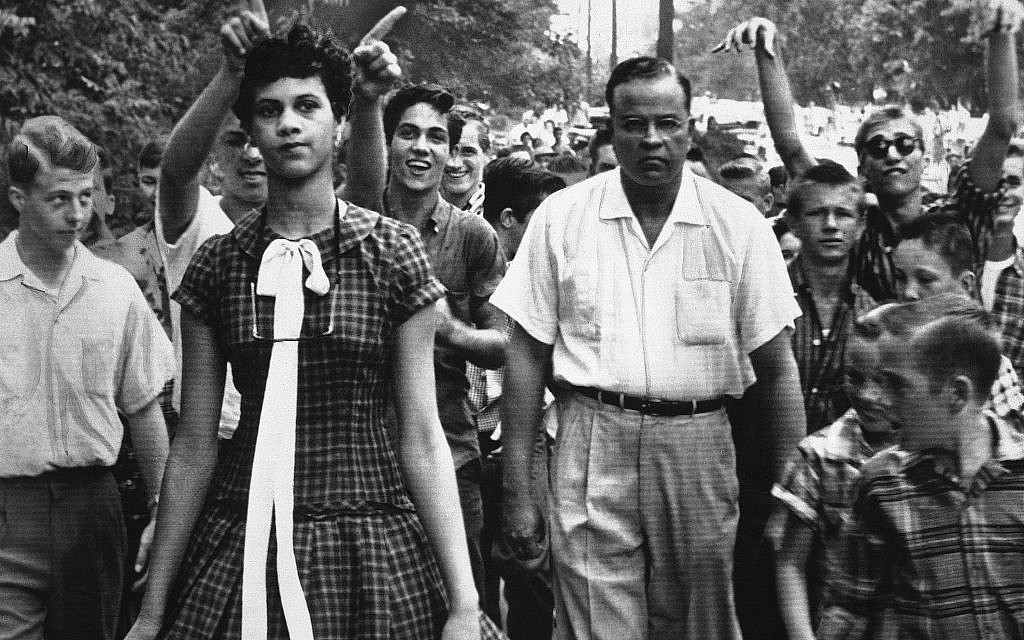 Dorothy Counts, 15, the first black student to attend Harding High School in Charlotte, North Carolina, is followed from school by shouting white students on Sept. 5, 1957. Dr. Edwin Tompkins, a family friend, escorted her. (AP Photo/Douglas Martin/Charlotte Observer)