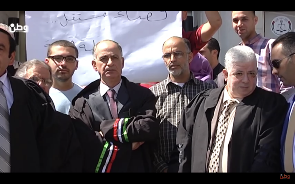 Members of the PA judiciary protest on the steps of the Supreme Judicial Council building in Ramallah. The poster declares, "an independent judiciary -- a strong state." September 20, 2016 (Screen shot from video) Members of the PA judiciary protest on the steps of the Supreme Judicial Council building in Ramallah. The poster declares, "an independent judiciary -- a strong state." September 20, 2016 (Screen shot from video)