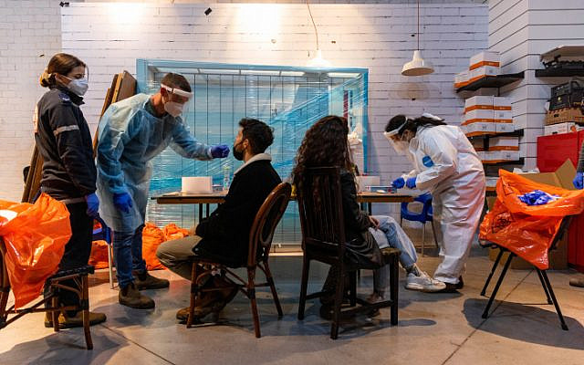 Magen David Adom workers conduct COVID-19 rapid antigen tests at an MDA testing center in Jerusalem on January 5, 2022. (Olivier Fitoussi/Flash90)
