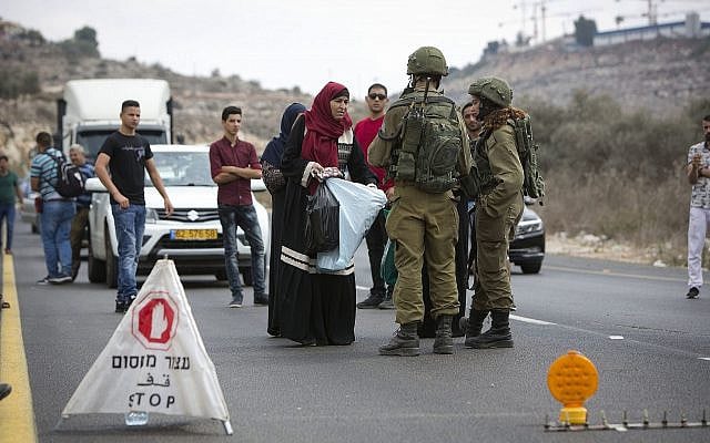 Palestinians wait at an Israeli checkpoint near the scene of a shooting attack at Barkan Industrial Zone in the northern West Bank on October 7, 2018. (AP Photo/ Majdi Mohammed) Palestinians wait at an Israeli checkpoint near the scene of a shooting attack at Barkan Industrial Zone in the northern West Bank on October 7, 2018. (AP Photo/ Majdi Mohammed)