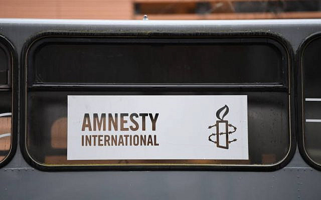 Berlin, Germany - February 17, 2017: Amnesty International sign. It is a non-governmental organisation focused on human rights that claims to have over 7 million members and supporters worldwide Berlin, Germany - February 17, 2017: Amnesty International sign. It is a non-governmental organisation focused on human rights that claims to have over 7 million members and supporters worldwide