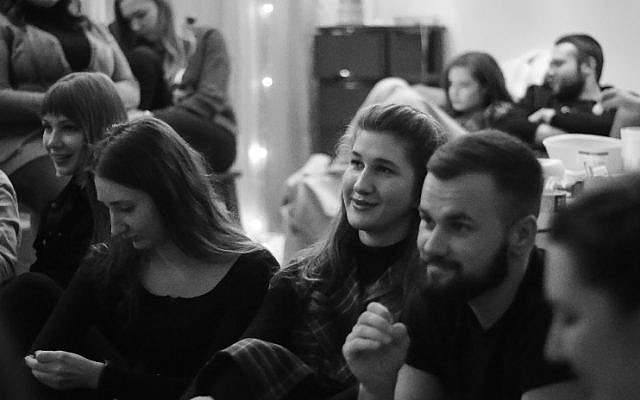 Residents and community members gather at Moishe House in Dnipro, Ukraine for a night of singing niggunim, or wordless Jewish melodies, March 2021. (Courtesy RSJ Moishe House)
