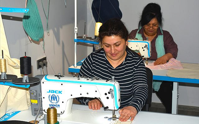 Women displaced by Armenia's most recent war with Azerbaijan sew traditional embroidery at the Resource Center for Women's Empowerment, an NGO in Hrazdan, Armenia. (Photo by Larry Luxner)