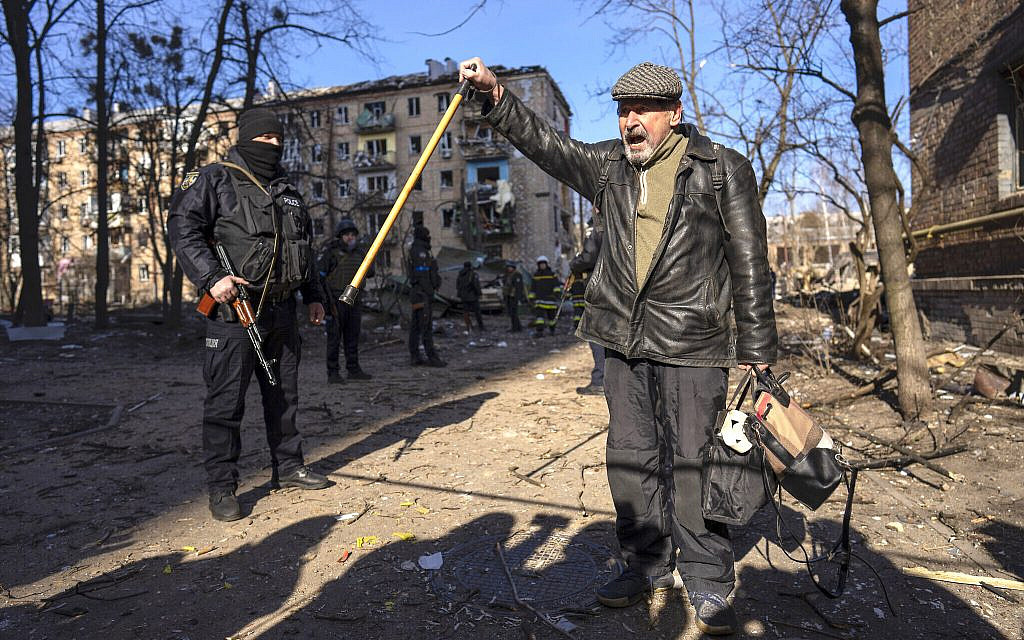 A man shouts anti Russian slogans at the site where a bombing damaged residential buildings in Kyiv, Ukraine,  March 18, 2022 (AP Photo/Rodrigo Abd)