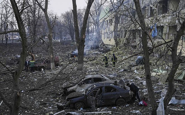 Ukrainian emergency employees work at the side of the damaged by shelling maternity hospital in Mariupol, Ukraine, March 9, 2022. (AP Photo/ Evgeniy Maloletka)