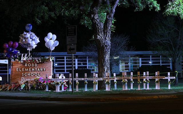 Crosses sit outside of Robb Elementary School in Uvalde, Texas, after a gunman killed 21 people inside, May 24, 2022. (Yasin Ozturk/Anadolu Agency via Getty Images)