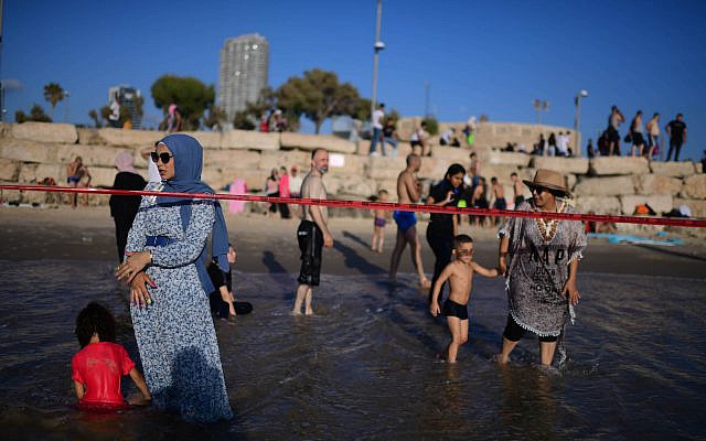 Israelis enjoy the sea by Tel Aviv during the third day of Eid al-Adha, on July 11, 2022. Muslims around the world are celebrating Eid al-Adha, the Festival of Sacrifice. (Tomer Neuberg/Flash90) Israelis enjoy the sea by Tel Aviv during the third day of Eid al-Adha, on July 11, 2022. Muslims around the world are celebrating Eid al-Adha, the Festival of Sacrifice. (Tomer Neuberg/Flash90)