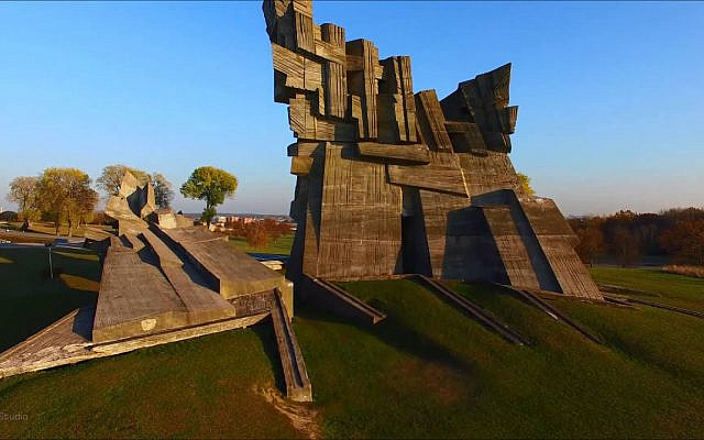 The Ninth Fort of Kaunas Fortress, the memorial to the victims of Nazism, designed by sculptor A. Ambraziunas, 1984. The mass burial place of the victims of the massacres carried out in the fort is a grass field, marked by a simple yet frankly worded memorial, reading: 'This is the place where Nazis and their assistants killed about 45,000 Jews from Lithuania and other European countries,' making no mention of Lithuanian collaboration. (screenshot, YouTube)