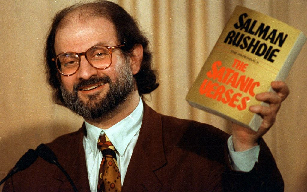Author Salman Rushdie holds up a copy of his book, 'The Satanic Verses' during a 1992 news conference in Arlington, Va.  (AP Photo/Ron Edmonds)