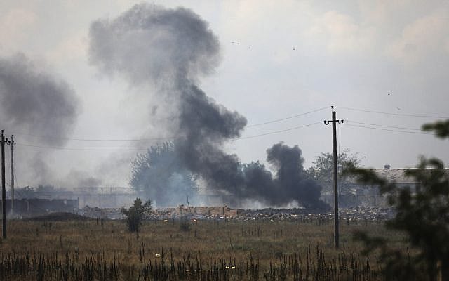 Smoke rises over the site of explosion at an ammunition storage warehouse of Russian army near the village of Mayskoye, in the Dzhankoi area of the Crimea, August 16, 2022. (AP Photo)
