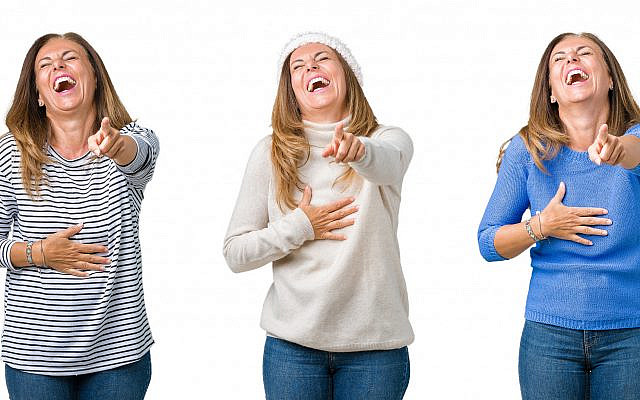 Illustrative. Women laughing and pointing. (iStock)